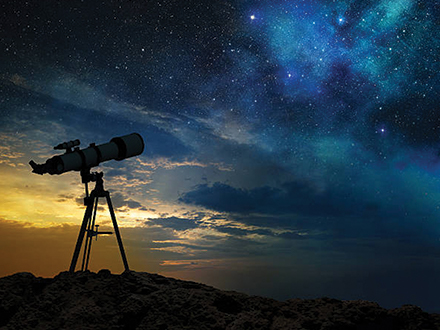 A telescope being used for stargazing. looking up at the night sky
